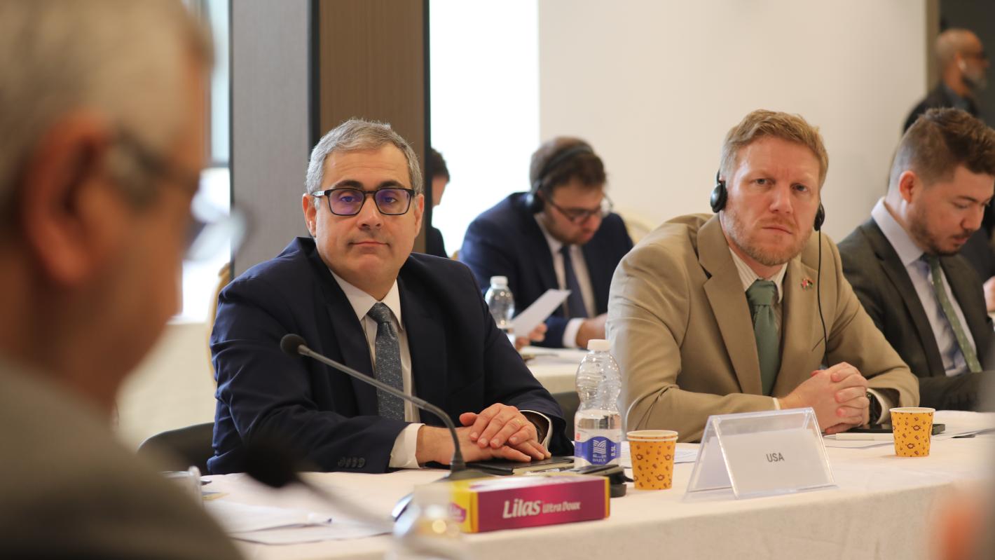 Representatives of the US and UK listen to members of the economic track of the Structured Dialogue