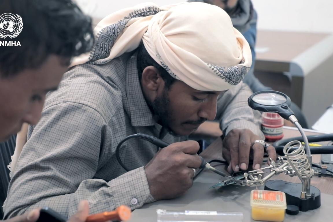 A man receives training in mobile phone repair A man receives training in mobile phone repair