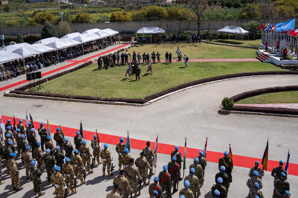 A procession of peacekeepers is photographed from above.