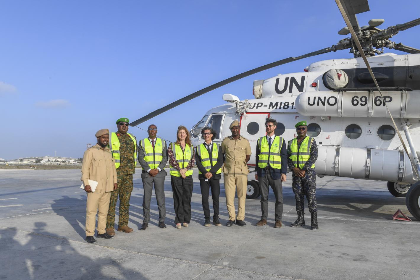 staff pose in front of helicopter