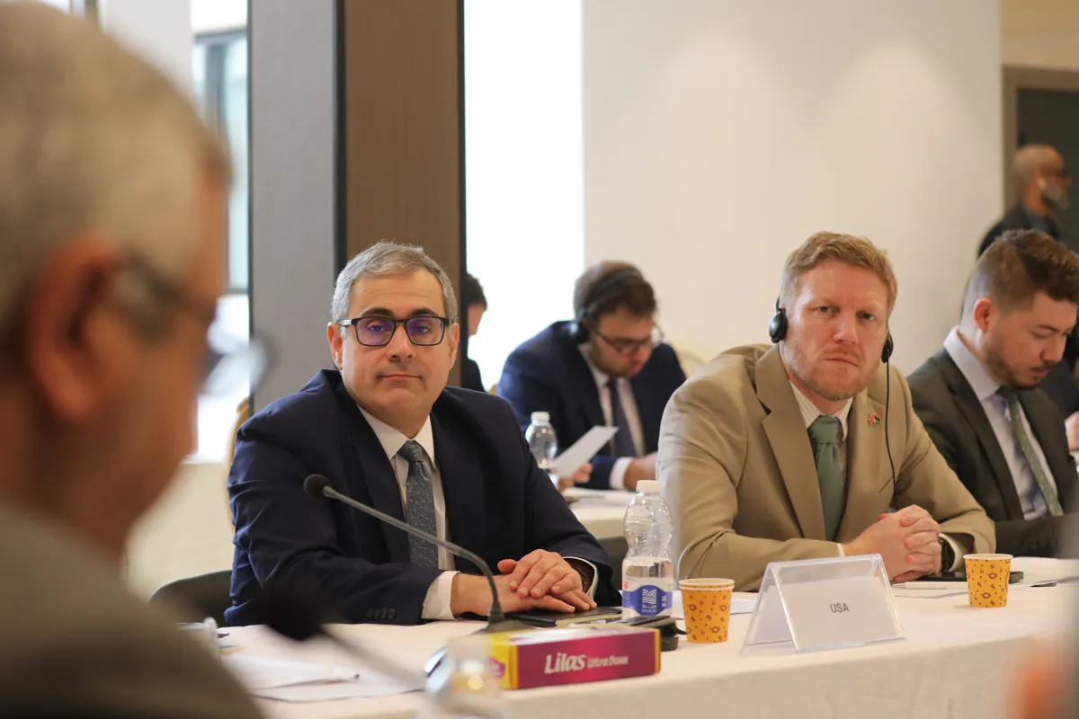Representatives of the US and UK listen to members of the economic track of the Structured Dialogue