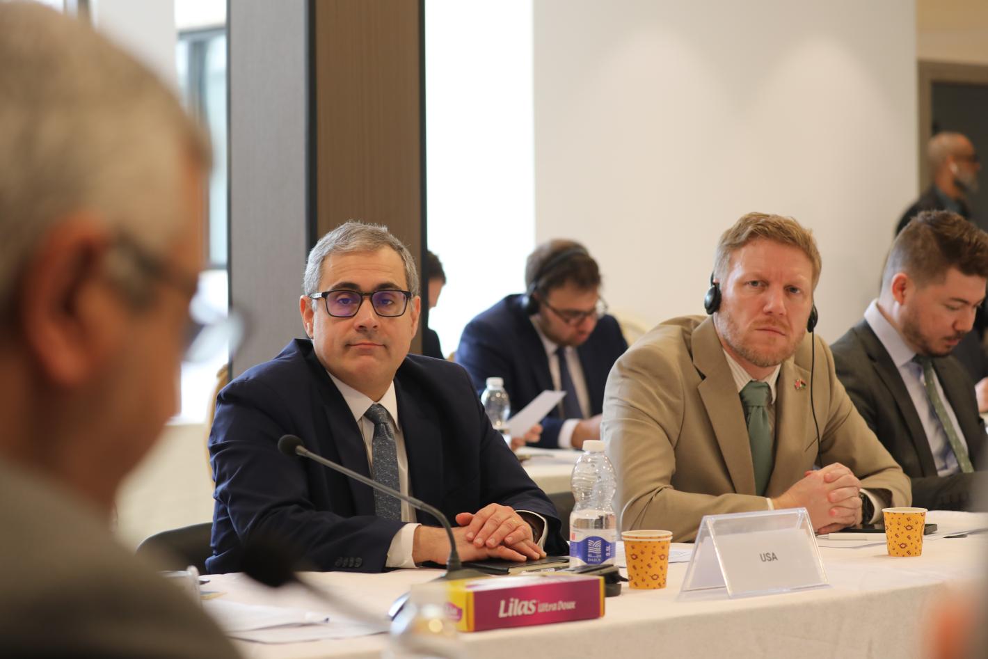 Representatives of the US and UK listen to members of the economic track of the Structured Dialogue