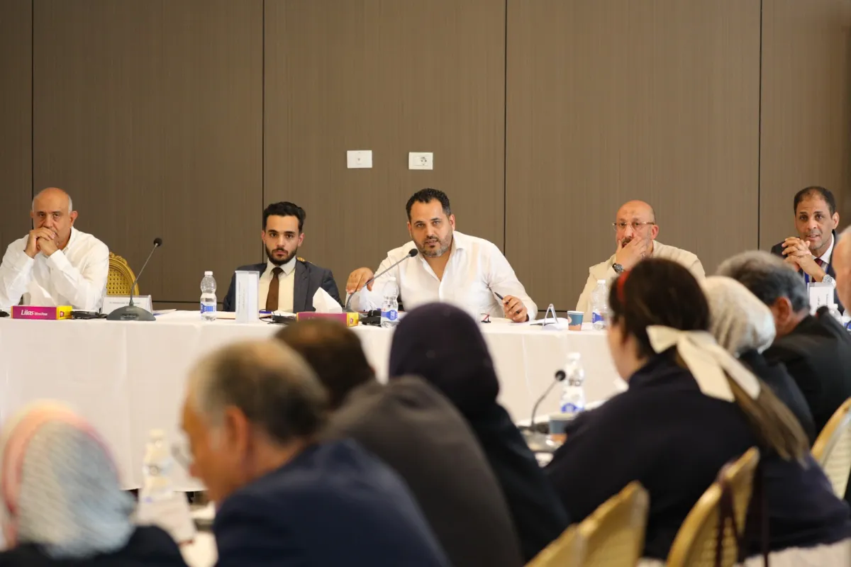 Members of the Structured Dialogue Governance Track sit around a table and discuss
