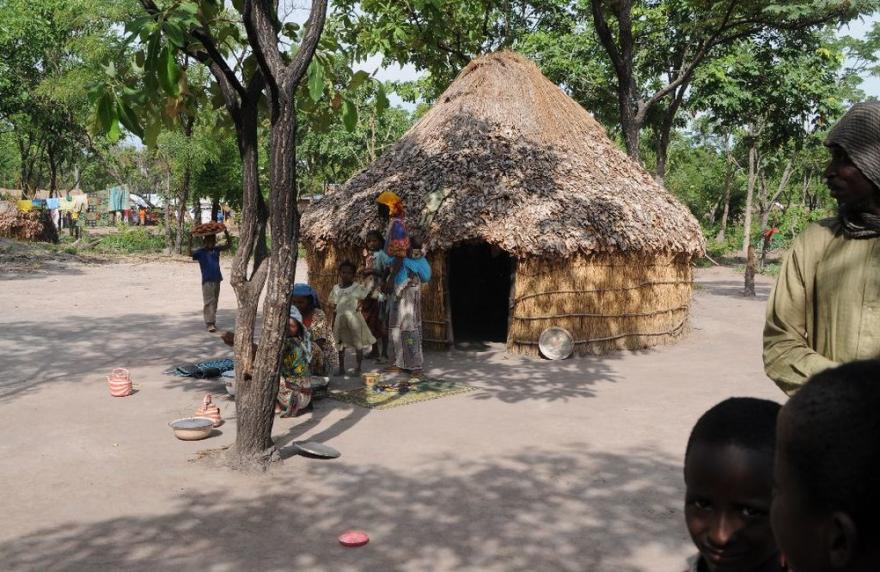 A traditional round house with a thatched roof